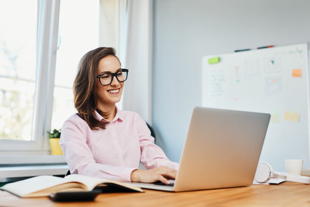 Person wearing glasses works on laptop at home