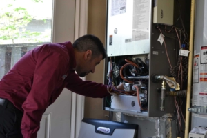 Expert Portland heat pump technician performing maintenance on a heat pump.