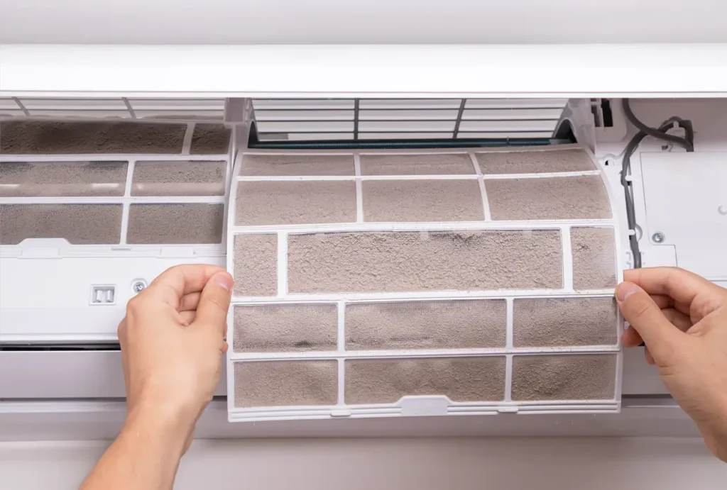 Technician replacing an HVAC filter in Portland home.