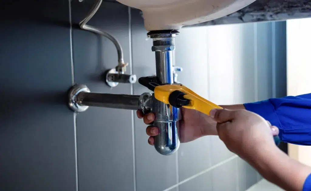 Plumber servicing a residential plumbing in Portland.