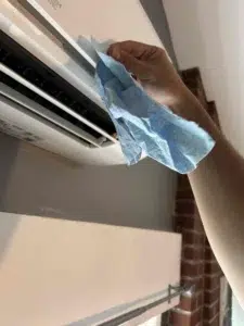 Technician cleaning mini-split indoor head blower wheel for improved airflow in Beaverton OR.