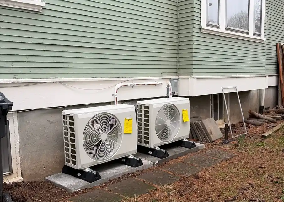 Two outdoor AC condenser units installed beside a Portland home for reliable cooling during long summer runtimes