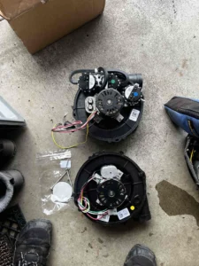 Technician repairing furnace flue boot and inducer motor components in Beaverton, OR