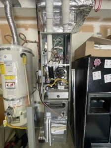 Technician diagnosing a gas furnace fan running with no heat in Beaverton, OR.