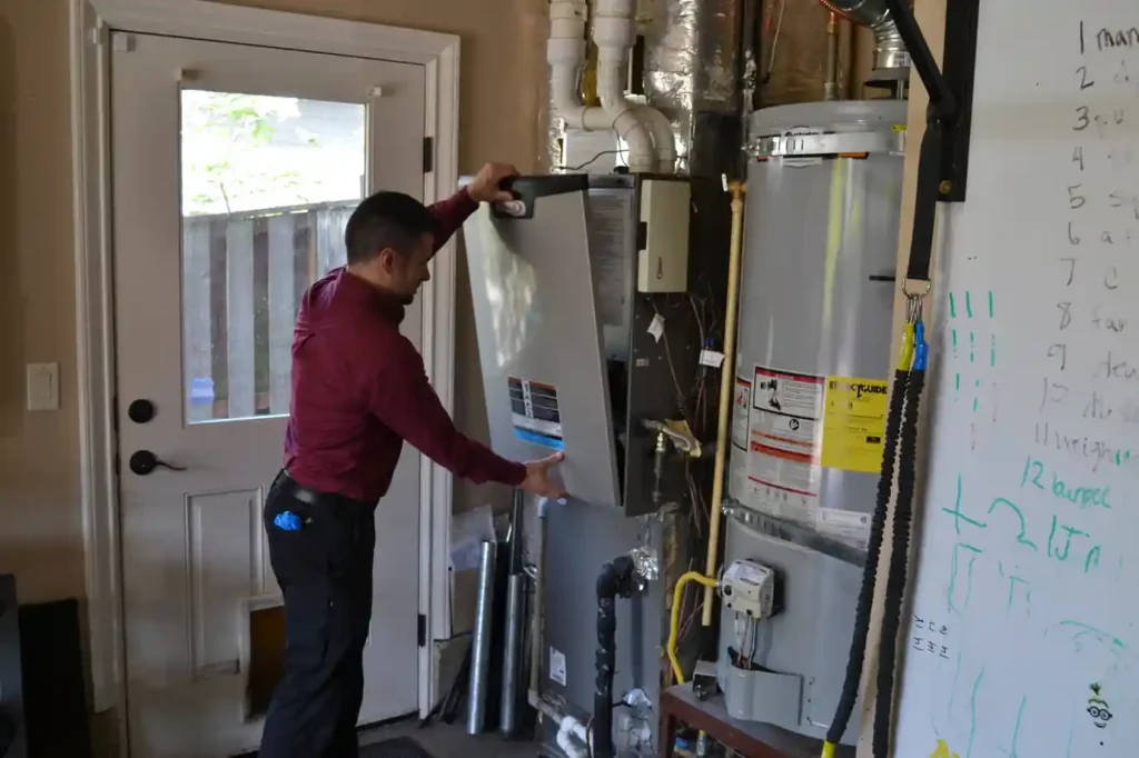 Technician inspecting a furnace in a Portland home before providing a repair cost estimate.