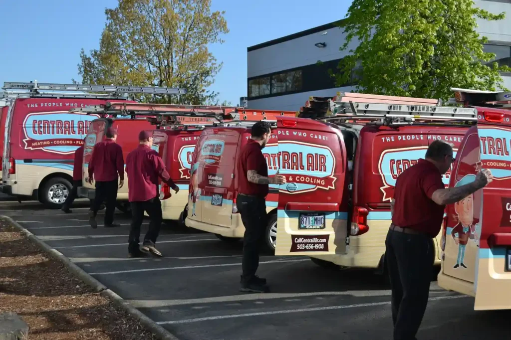 Technicians with Central Air service vans for local furnace repair and diagnostics.