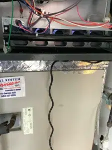 Technician servicing a Portland furnace with an ignition problem.